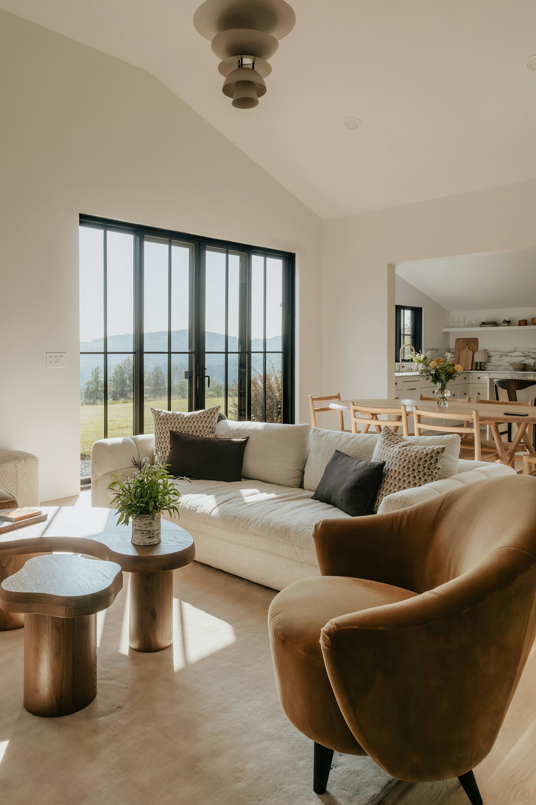Sunlit photographed living room with a beige sofa and warm wood accents