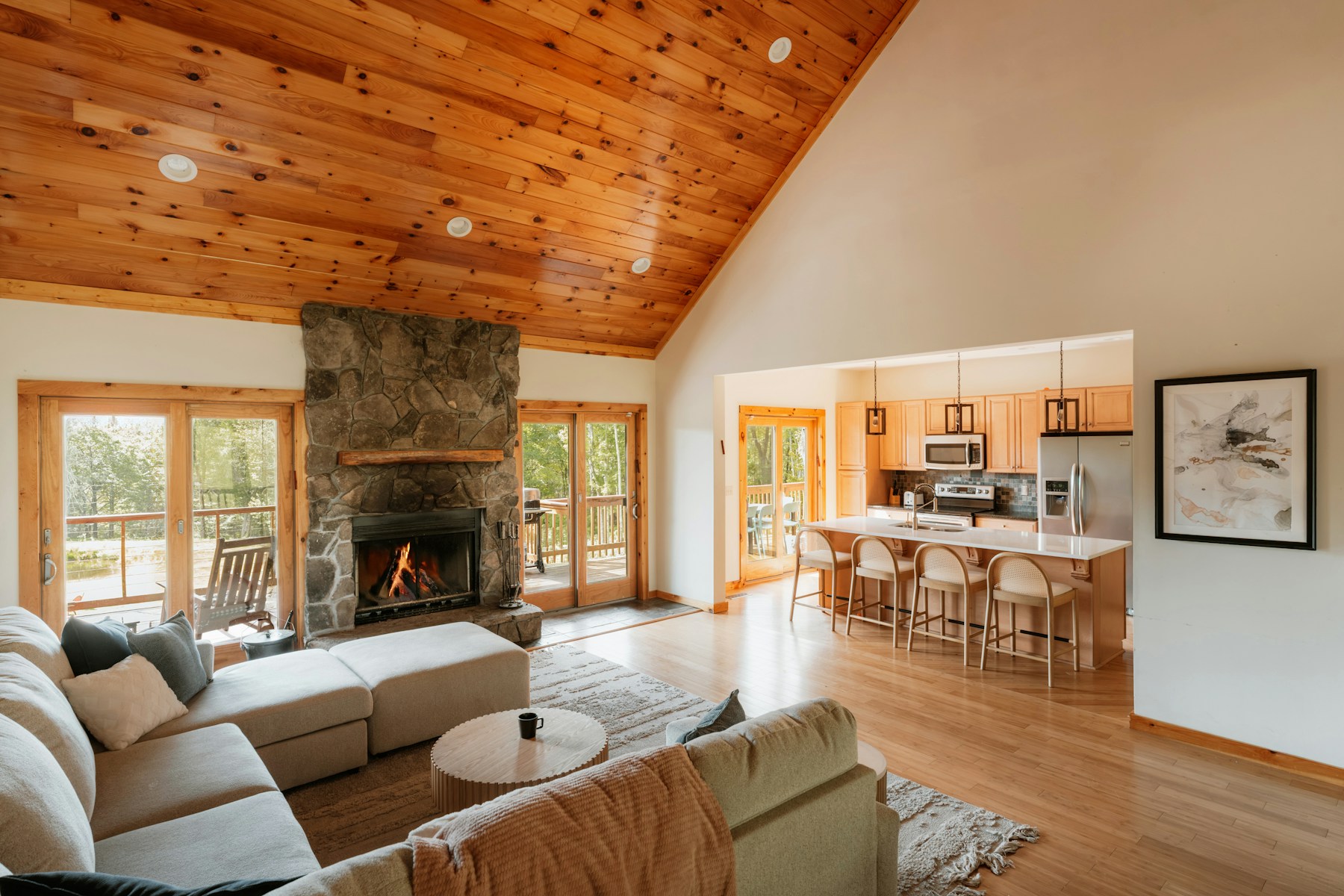 Photographed cabin living room with a stone fireplace