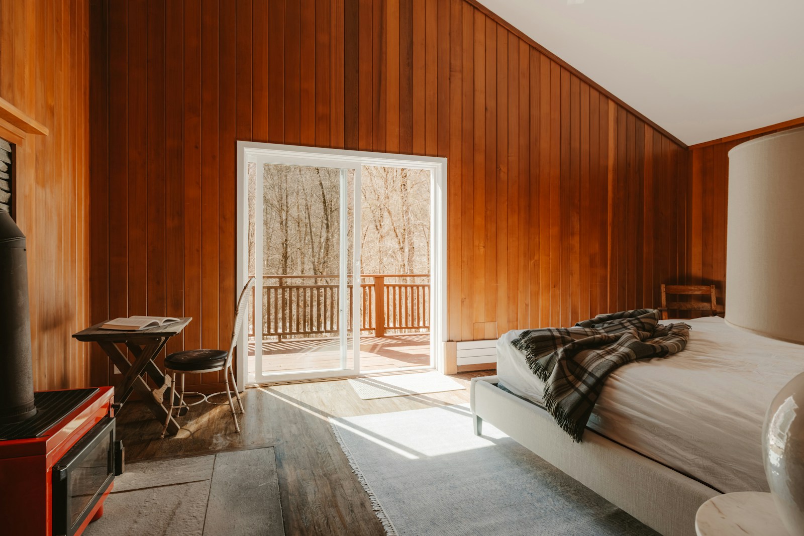 Photographed wood-panelled bedroom with natural light